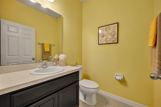 bathroom featuring vanity, tile patterned floors, and toilet