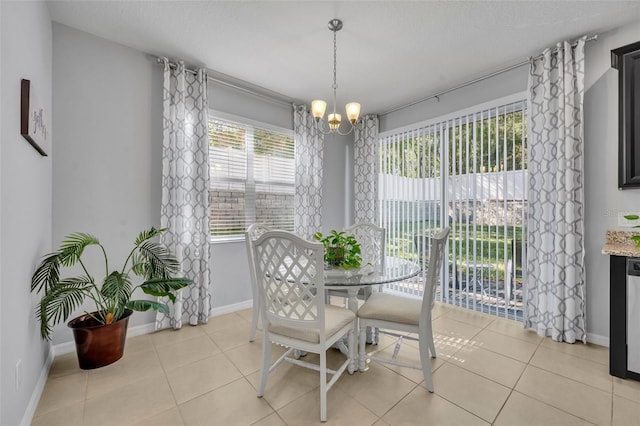 tiled dining space featuring an inviting chandelier