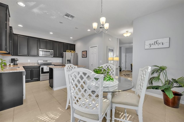 tiled dining area featuring an inviting chandelier and sink