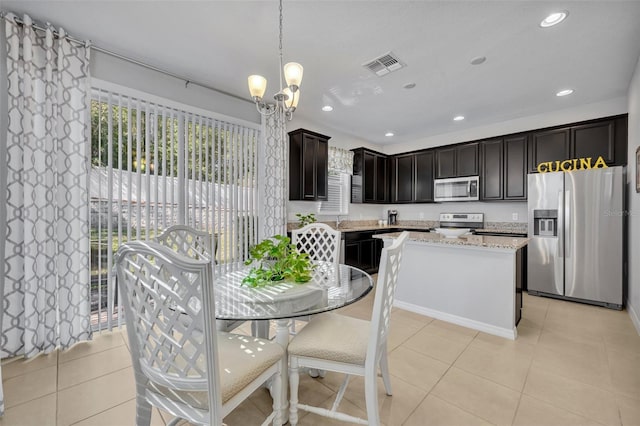 kitchen featuring pendant lighting, light tile patterned floors, sink, appliances with stainless steel finishes, and dark brown cabinets