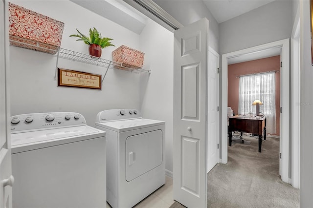 laundry room featuring light carpet and washer and dryer