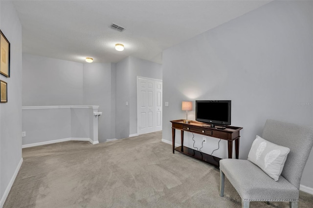 sitting room featuring light carpet