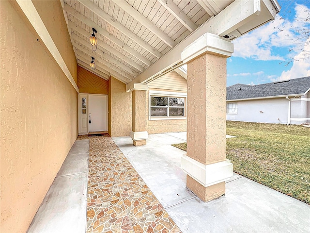 doorway to property featuring a yard and a patio area