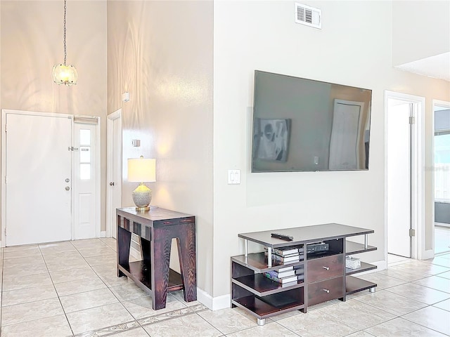 tiled foyer featuring a high ceiling