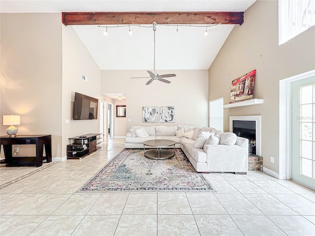 tiled living room with ceiling fan, high vaulted ceiling, rail lighting, and beamed ceiling