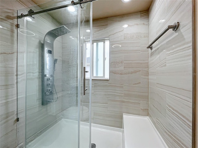 bathroom with a shower with door