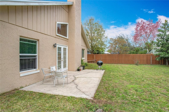 view of yard featuring a patio area and french doors