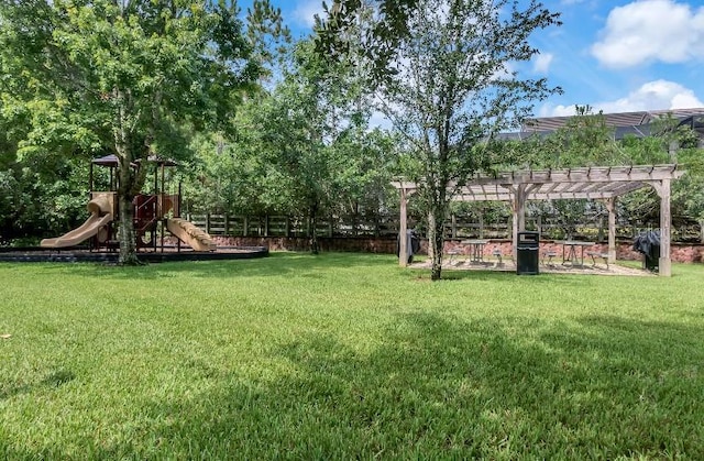 view of yard featuring playground community and a pergola