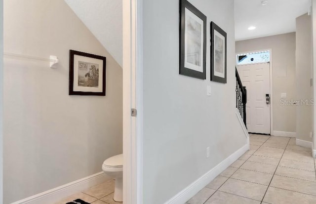 corridor featuring light tile patterned floors, stairs, baseboards, and recessed lighting