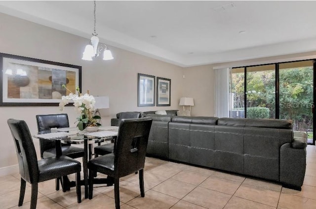 dining space with light tile patterned floors, baseboards, and a chandelier