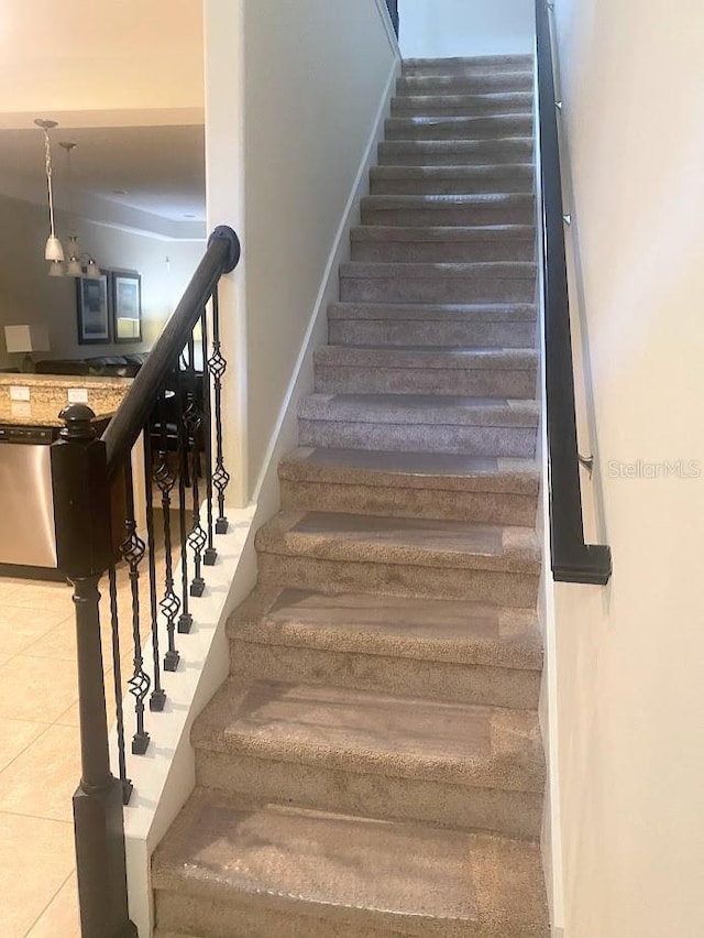 staircase featuring tile patterned flooring