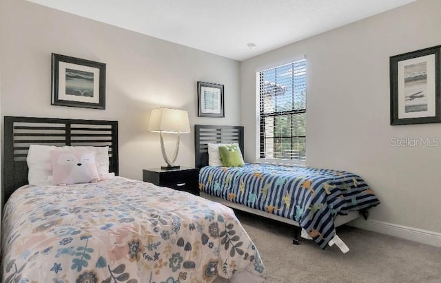 bedroom with carpet and baseboards