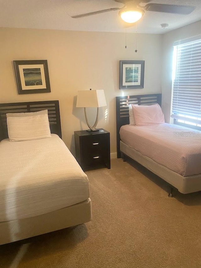 carpeted bedroom with a ceiling fan