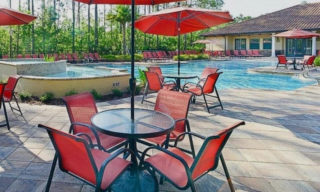 pool featuring a patio area and a jacuzzi