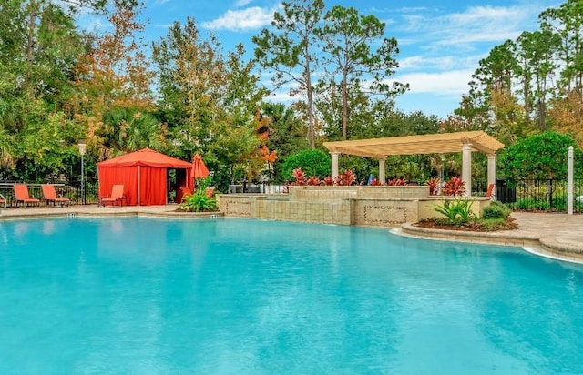 pool featuring a patio area, fence, and a pergola