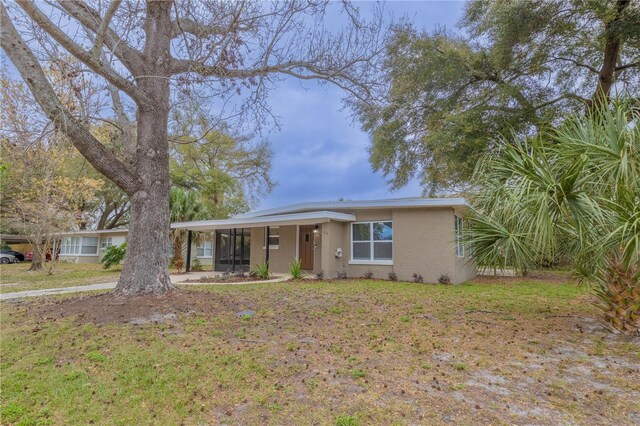 view of front of property with a front yard and stucco siding