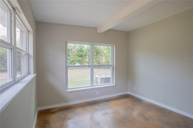 unfurnished room featuring concrete flooring, beam ceiling, and baseboards