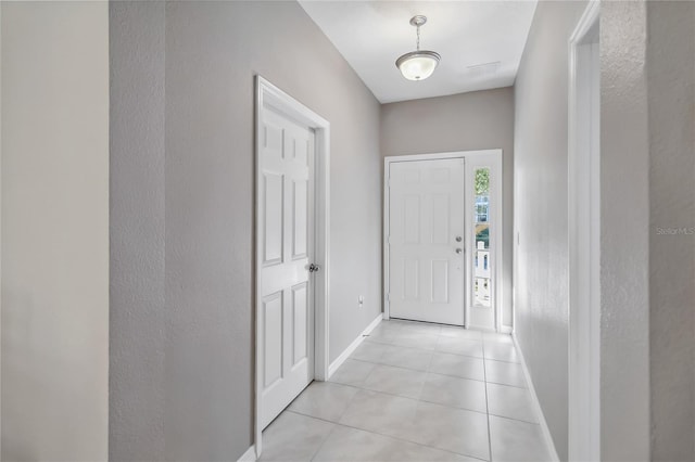 doorway with light tile patterned floors