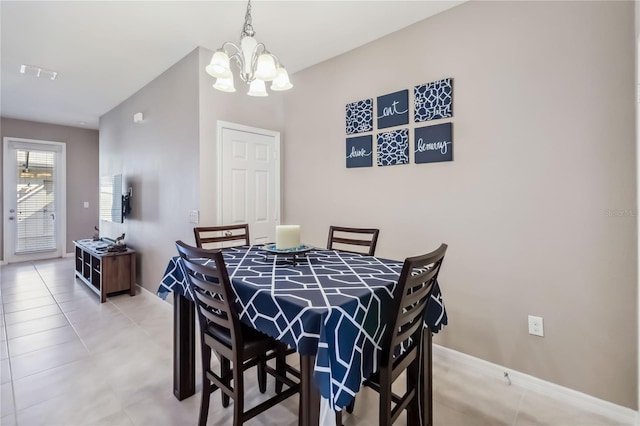 tiled dining area with an inviting chandelier