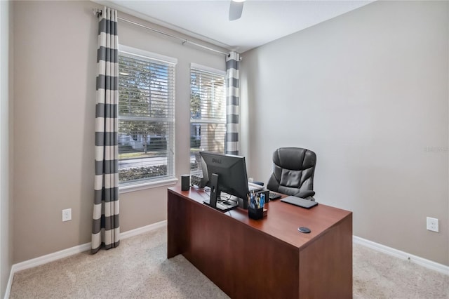 carpeted home office with ceiling fan