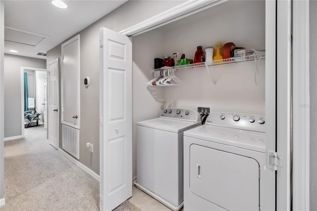 laundry area featuring separate washer and dryer and light colored carpet