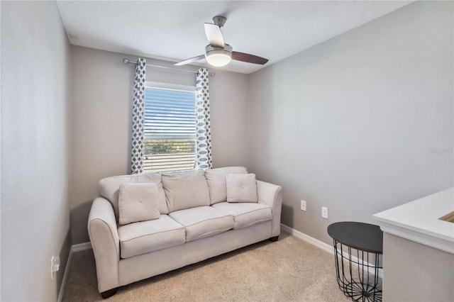 carpeted living room featuring ceiling fan