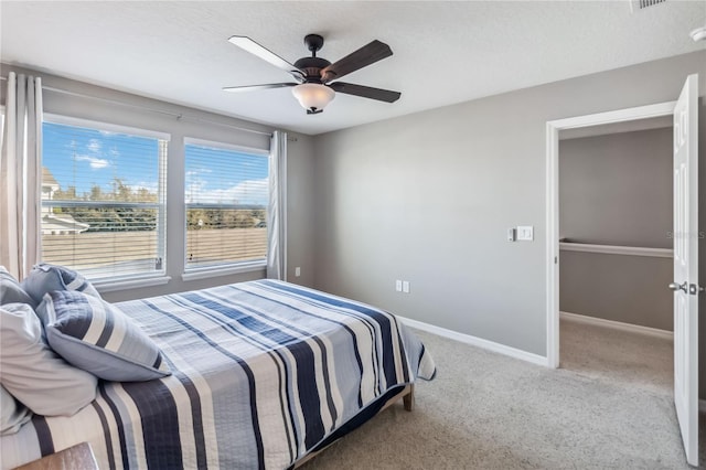 bedroom featuring a textured ceiling, carpet floors, and ceiling fan