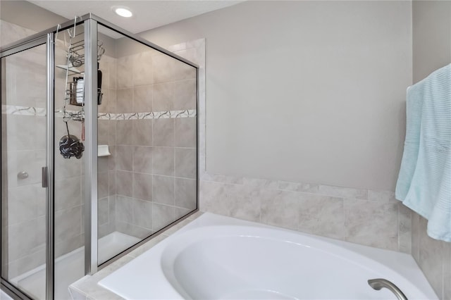 bathroom featuring separate shower and tub