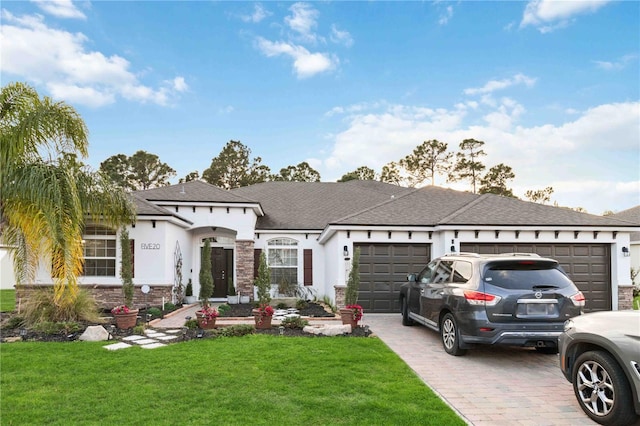 view of front facade with a garage, roof with shingles, decorative driveway, a front lawn, and stucco siding