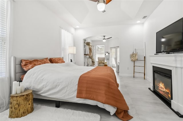 bedroom featuring ceiling fan and a raised ceiling