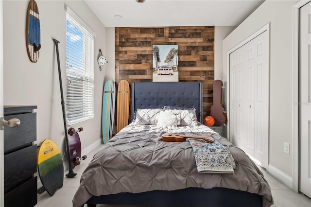 bedroom with wooden walls and a closet