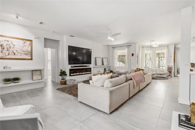 tiled living room with ceiling fan