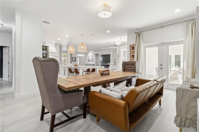 tiled dining room featuring french doors