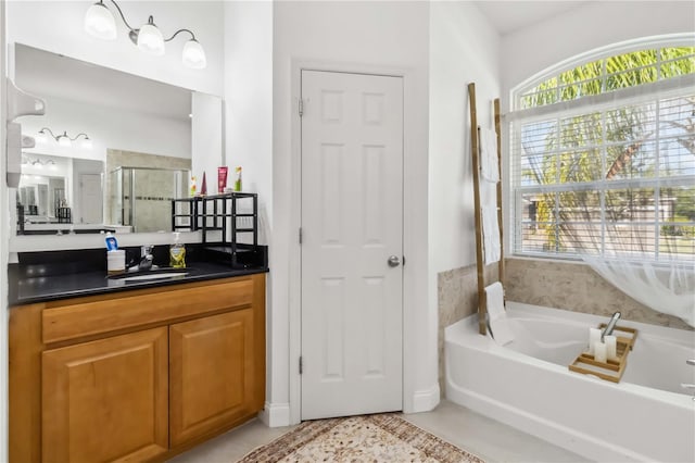 bathroom featuring vanity, tile patterned flooring, and shower with separate bathtub