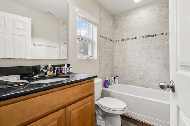 full bathroom with vanity, toilet, and tiled shower / bath combo