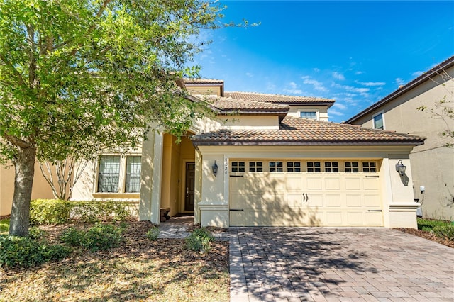 mediterranean / spanish-style house with a garage