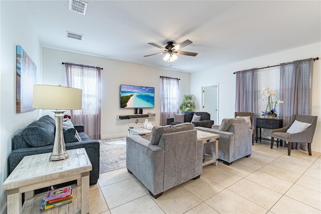 living room with plenty of natural light, light tile patterned floors, and ceiling fan