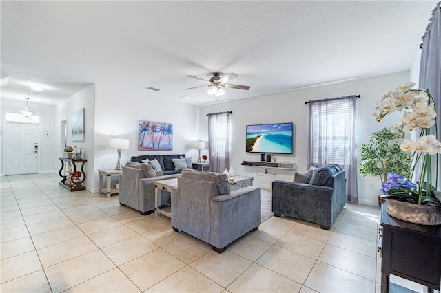 living room featuring a healthy amount of sunlight, light tile patterned floors, and ceiling fan