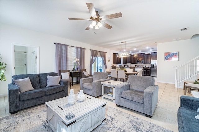 living room featuring ceiling fan and light tile patterned flooring