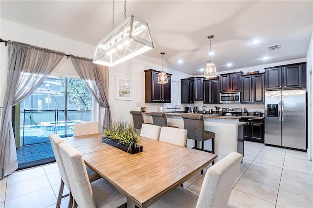 dining area with light tile patterned floors and sink