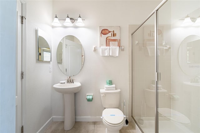 bathroom featuring walk in shower, toilet, and tile patterned flooring