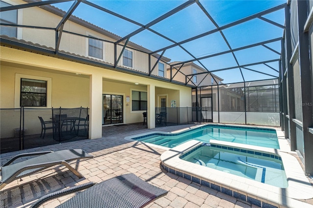 view of pool featuring an in ground hot tub, a lanai, and a patio