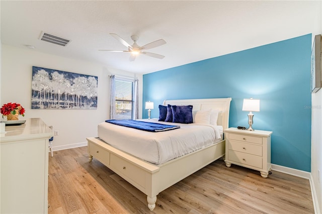 bedroom with ceiling fan and light hardwood / wood-style floors