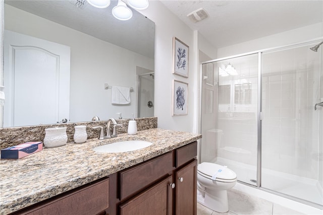 bathroom with tile patterned flooring, vanity, an enclosed shower, a textured ceiling, and toilet