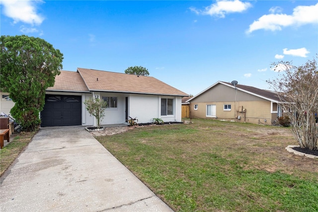 single story home featuring a garage and a front lawn