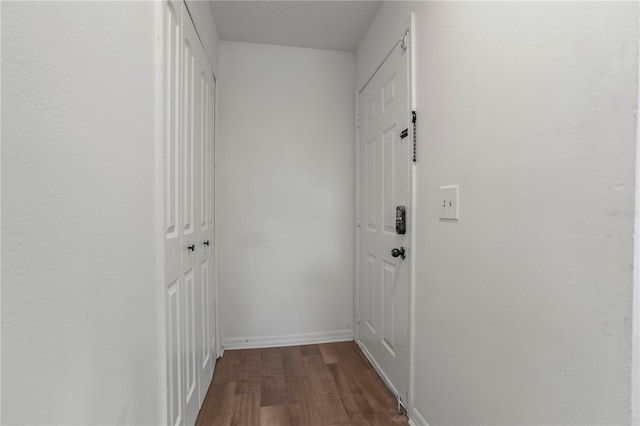 hallway with hardwood / wood-style floors