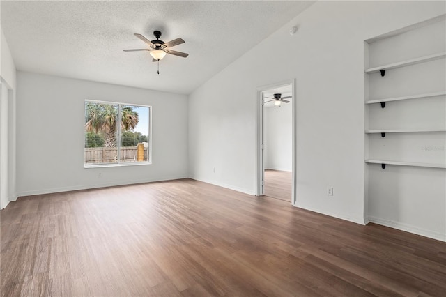 unfurnished bedroom featuring ceiling fan, lofted ceiling, dark hardwood / wood-style floors, and a textured ceiling