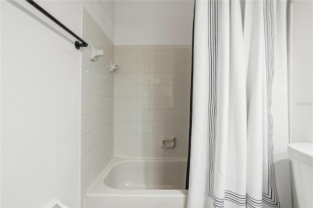 bathroom with shower / bathtub combination with curtain and toilet