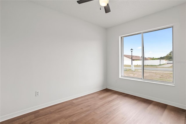 empty room with wood-type flooring and ceiling fan