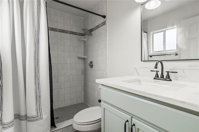 bathroom featuring walk in shower, vanity, and toilet